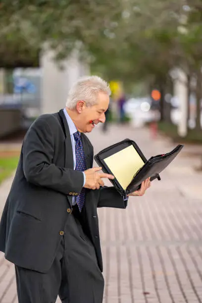 Businessman fumbling through his notebook