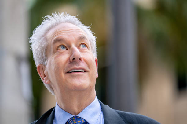istock Handsome mature businessman glancing up 1367436798