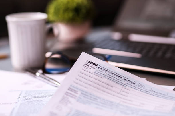 istock Tax: USA Income Tax forms and supporting preparation materials. 1367439493