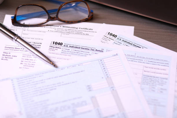 istock Tax: USA Income Tax forms and supporting preparation materials. 1367439498