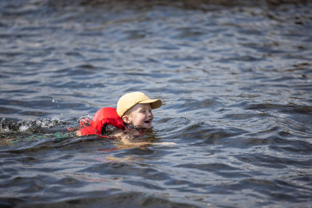 istock Young Boy Swimming in the Lake during Summer 1367439501