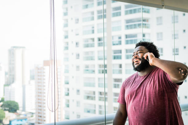 istock Talking on the phone, a young man smiles 1367441029