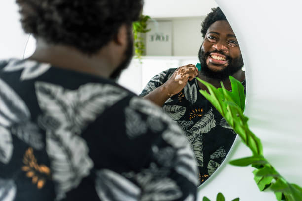 istock Man looks in the mirror smiling 1367441094
