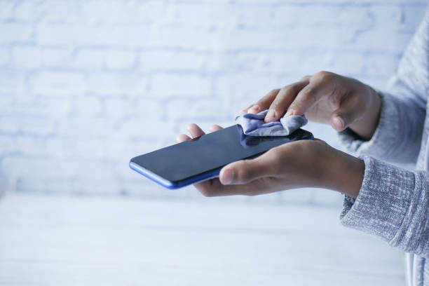istock cleaning mobile phone display for preventing virus 1367441117