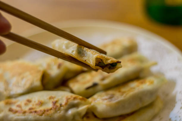istock Soft focus of a Korean dumplings between chopsticks 1367441153