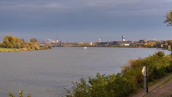 Duisburg, North Rhine-Westfalia, Germany - November 11, 2019: Ships on the River Rhine, seen from the Rheinpromenade Wanheim