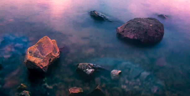 istock Rocks on a serene blue sea 1367446696