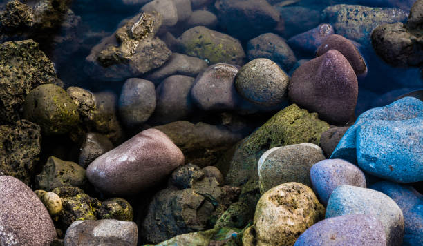 istock Rocks on a serene blue sea 1367446714