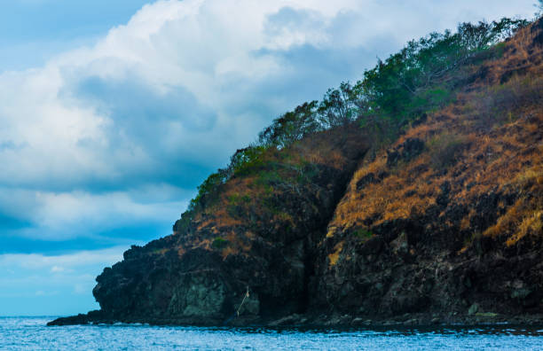 istock Rock Island over scenic blue sea water. 1367446785