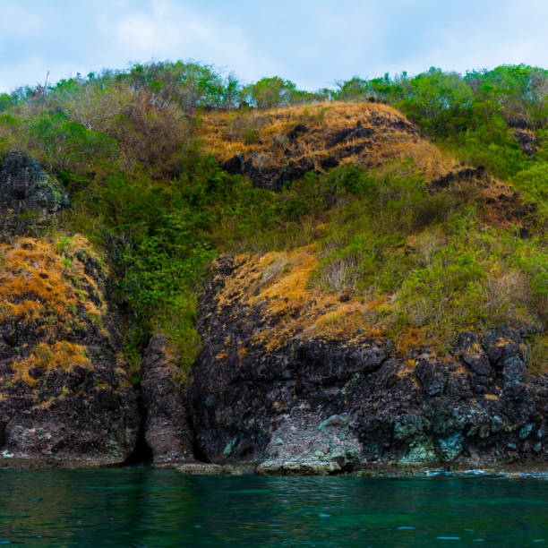 istock Rock Island over scenic blue sea water. 1367446819