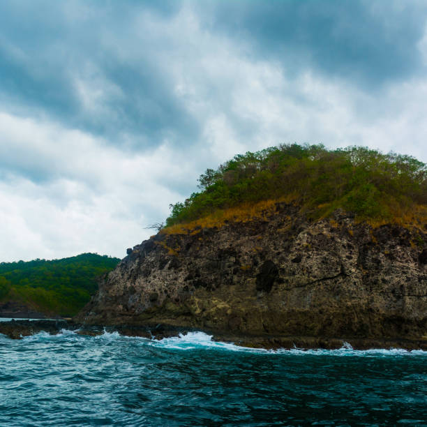 Rock Island over scenic blue sea water.