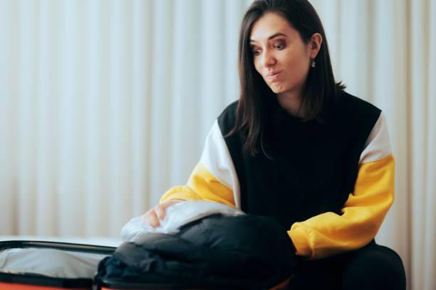 istock Stressed Woman Packing her Bags Going on Vacation 1367449662
