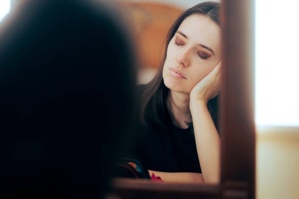 istock Sad Depressed Woman Crying Looking in the Mirror 1367449663
