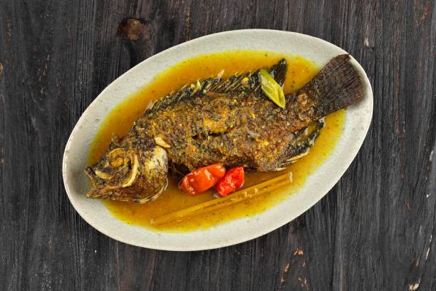 istock Pesmol Ika Nila, Tilapia Yellow Curry, Popular Curry Recipe 1367452741