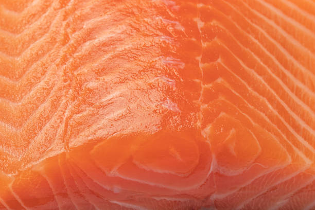 istock Salmon fish orange meat with fatty layer close-up texture. 1367455136