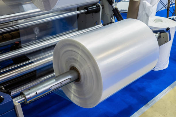 industrial machine with roll of newly produced transparent plastic film stock photo