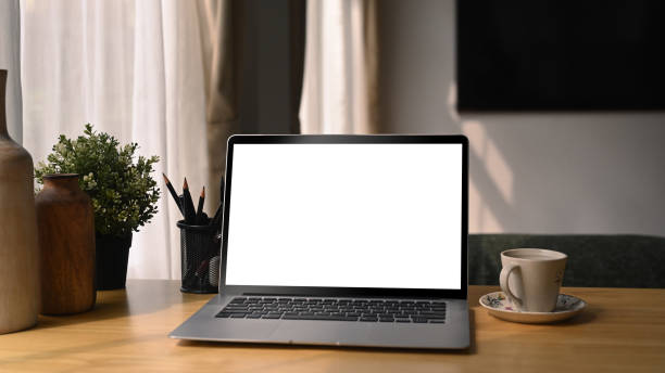 istock Comfortable workplace with laptop computer, coffee cup and houseplant on wooden desk. 1367460809