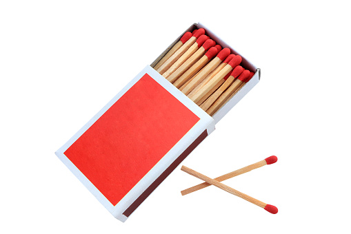 Open full box of matches on white background. two more matches near the match box with clipping path.