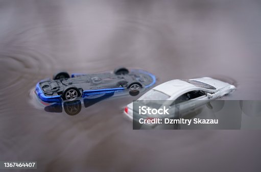 istock Two cars were flooded, one overturned as a result of the flood. One of them is out of focus. 1367464407