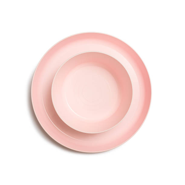 istock set of pink plastic plates for first and second courses isolated on white 1367466643