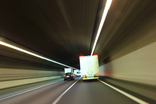 istock Truck driving through the highway tunnel 1367468324