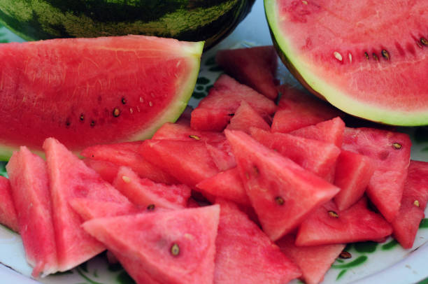 Watermelon Watermelon sliced on a enamel plate Watermelon stock pictures, royalty-free photos & images