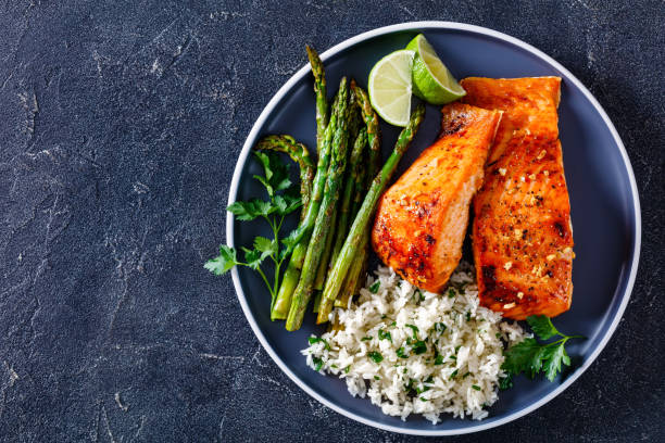 fried salmon fish fillet with rice and asparagus
