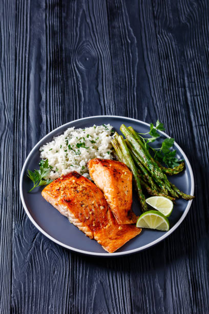 istock fried salmon fish fillet with rice and asparagus 1367472442