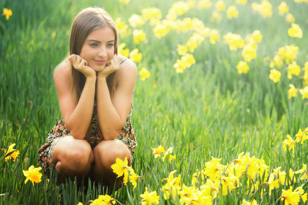 Daffodil field in the spring with a young beauty