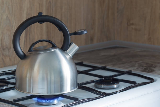 istock metal silver modern kettle on   gas stove in kitchen 1367474402