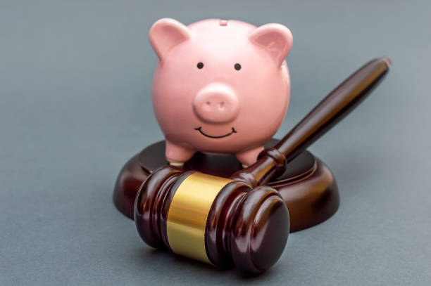istock Gavel with piggy bank on grey background. 1367475705