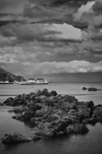 Black and white photo of rocks on seashore