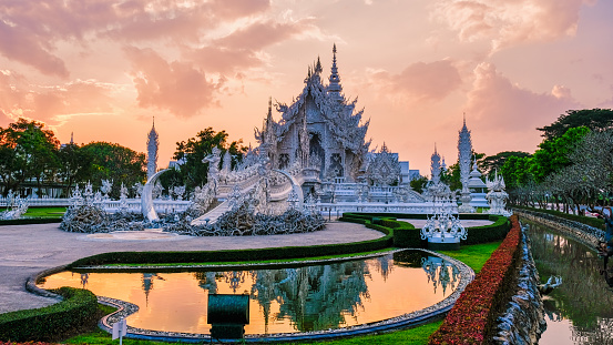 White temple Chiang Rai during sunset, Evening view of Wat Rong Khun or White Temple, Landmark in Chiang Rai, Thailand. Asia