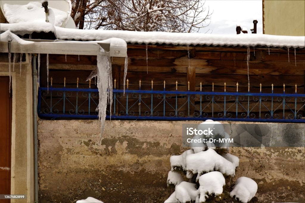 Frozen Downspout. Common issue your gutter may encounter during winter. ice forms inside the downspouts for rain gutters in Erzurum, Turkey. Cold weather -50 degrees Celsius. snow, icing, freezing Asia Stock Photo