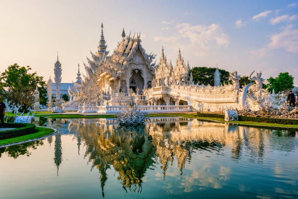 White temple Chiang Rai during sunset, Evening view of Wat Rong Khun or White Temple, Landmark in Chiang Rai, Thailand stock photo