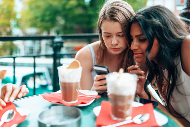 istock people with smartphone at the cafe 1367485293