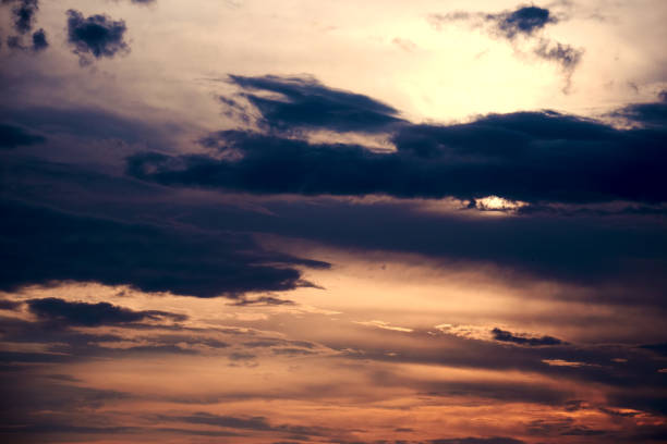 istock Dramatic dusk sky with many dark clouds and sunbeams 1367486022