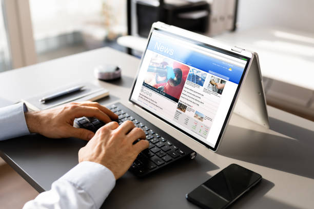 istock Watching News On Screen. Reading Newspaper Website 1367489227