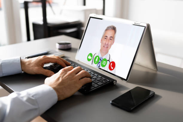 istock Video Chatting With Doctor At Desk 1367489233