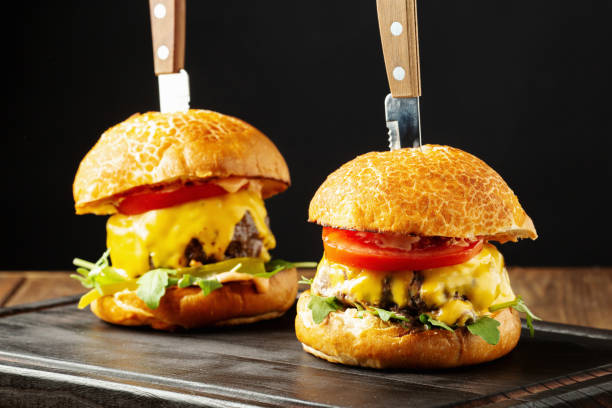 istock Cheeseburgers with tomatoes and arugula 1367489579