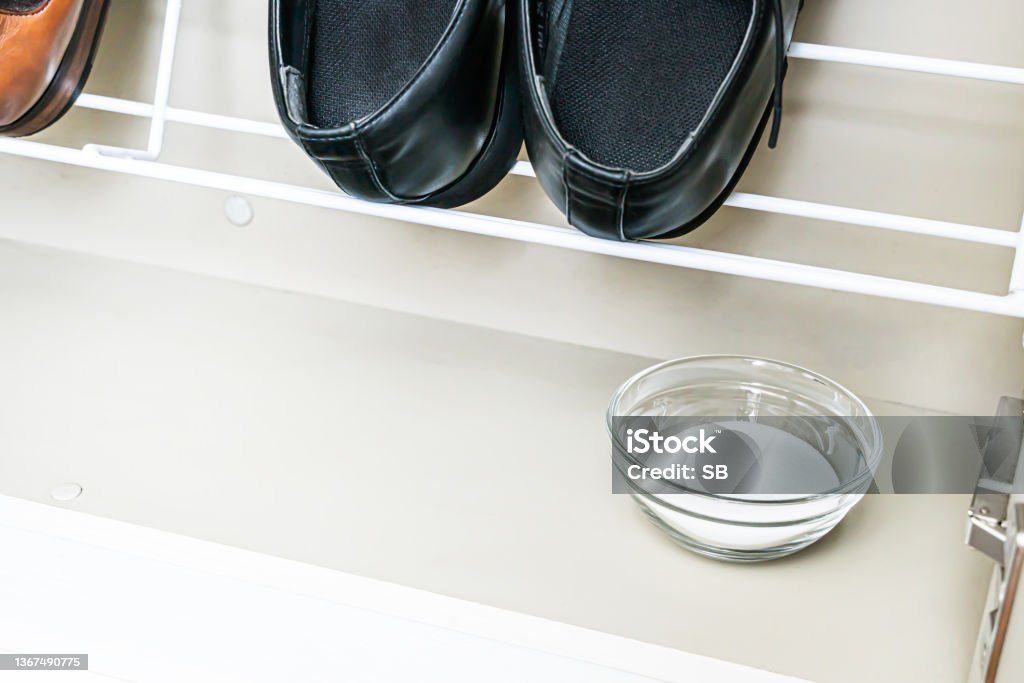 Baking soda in shoes closet. Shoe Rack Stock Photo