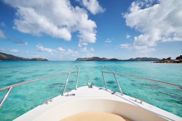 Bow of ship at sea between beautiful tropical islands