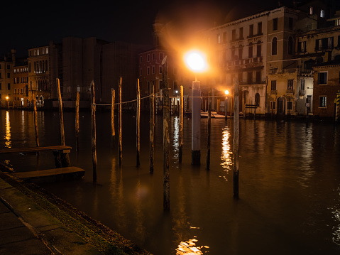 Mooring Posts on the Grand Canal or Canal Grande in Venice, Italy Illuminated at Night