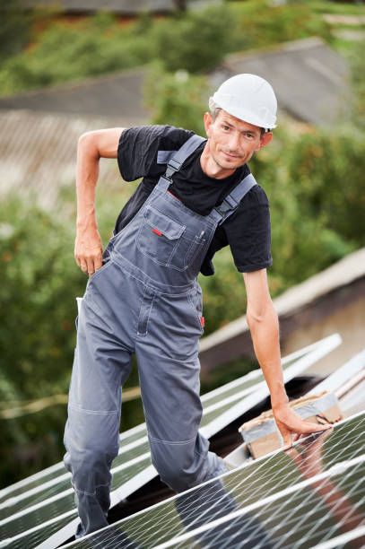 istock Portrait of man technician mounting solar panels on roof 1367492965