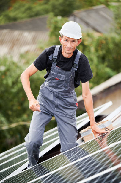 istock Portrait of man technician mounting solar panels on roof 1367492979