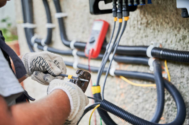 istock Electrician installing solar panel system, wiring inverter and electric box 1367492988