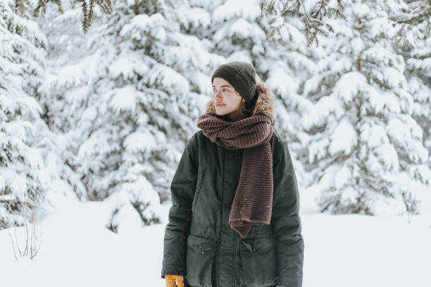 istock Young woman in snowy forest 1367493864
