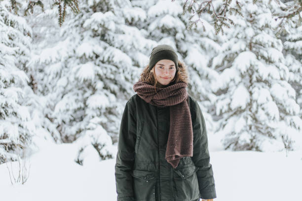 istock Young woman in snowy forest 1367493866