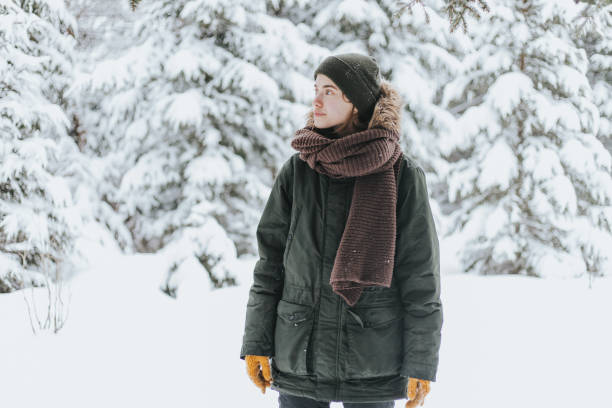 istock Young woman in snowy forest 1367493869