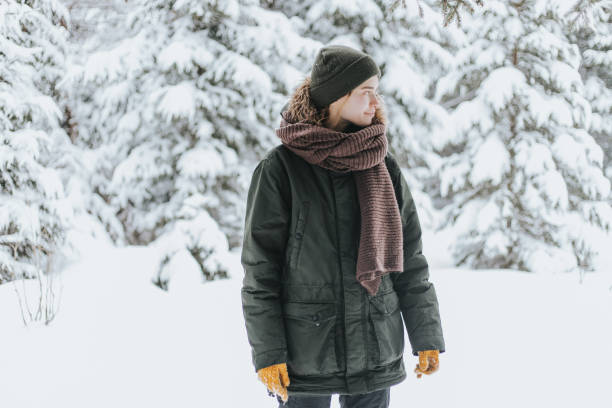 istock Young woman in snowy forest 1367493897